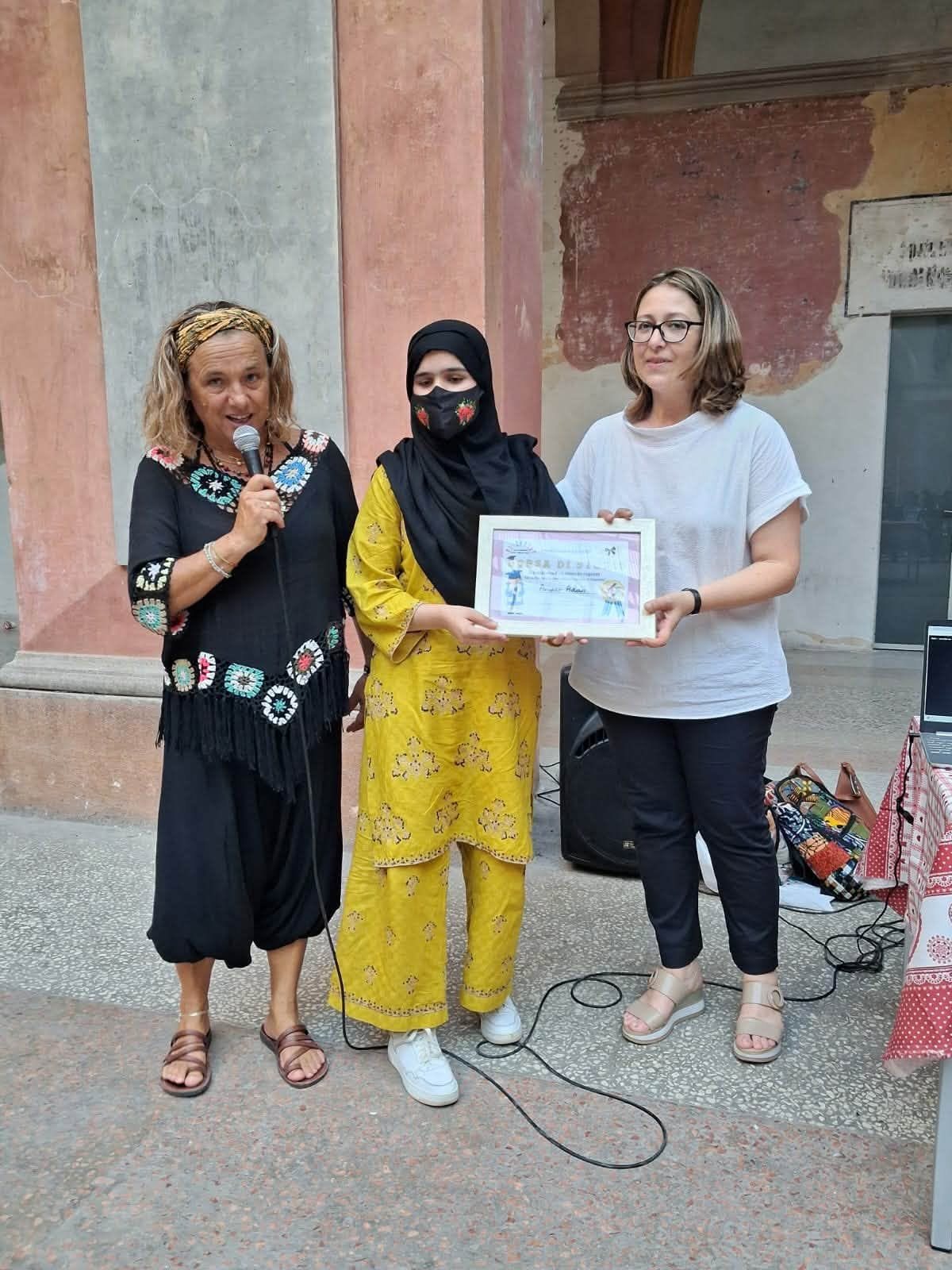 La consegna di una borsa di studio a una ragazza, sotto il portico